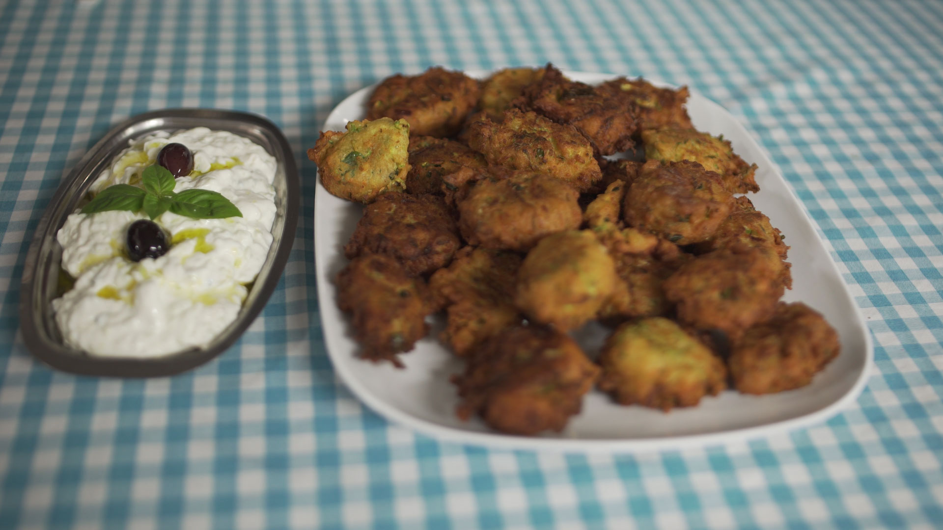 Zucchini Fritters with Tzatziki made with Kastania Extra Virgin Olive Oil on plaid tablecloth